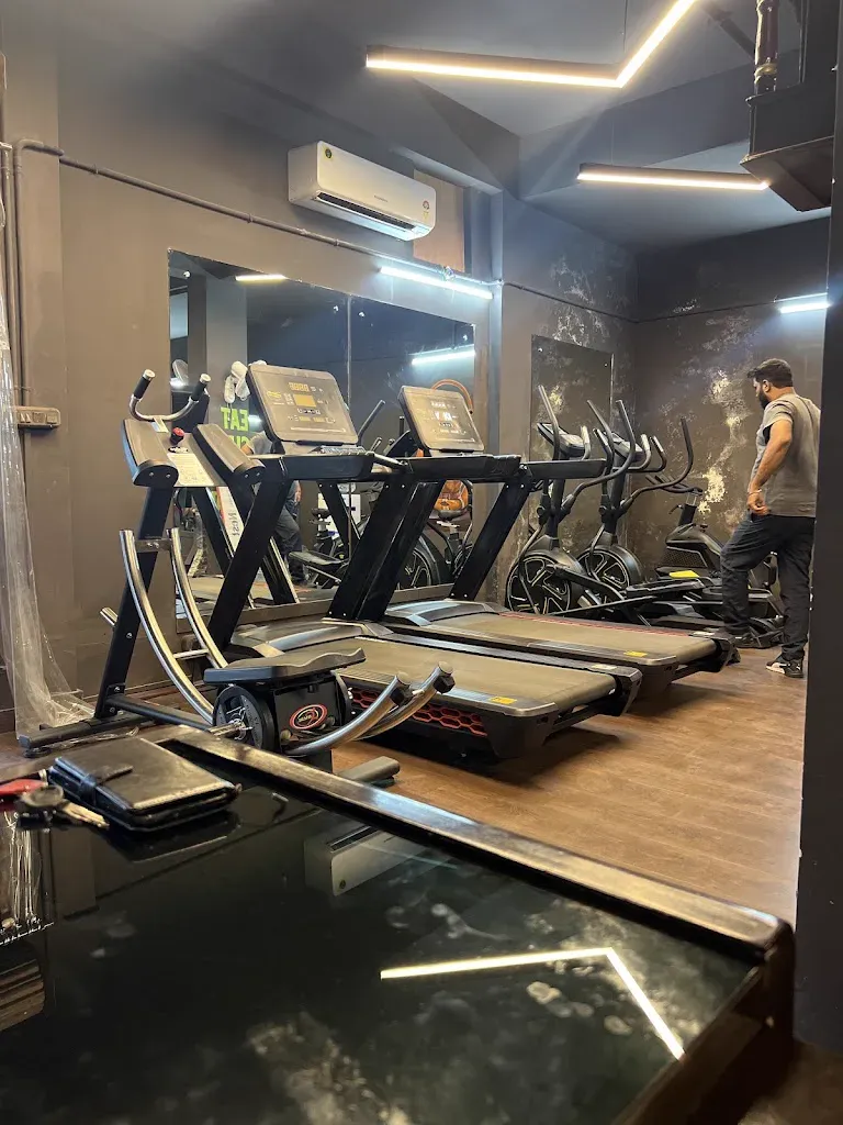 A row of treadmills and cross-trainers in the air-conditioned cardio zone